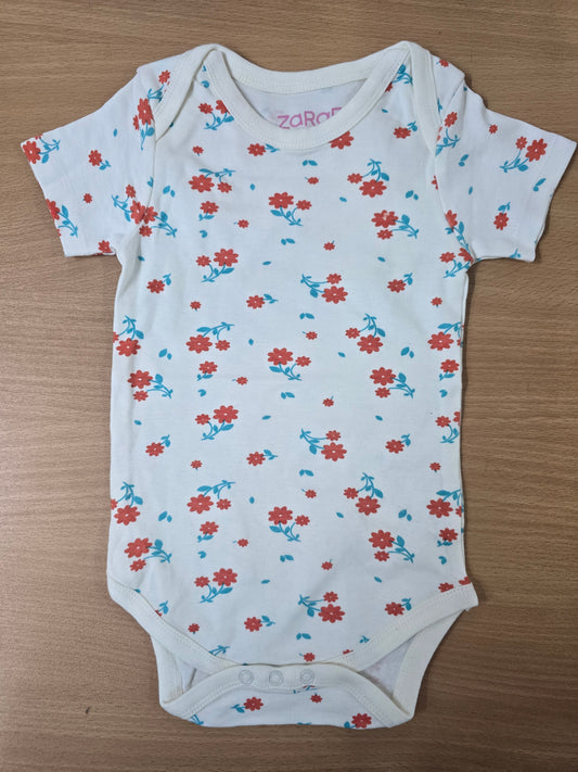 Baby's rompers - White with orange flowers