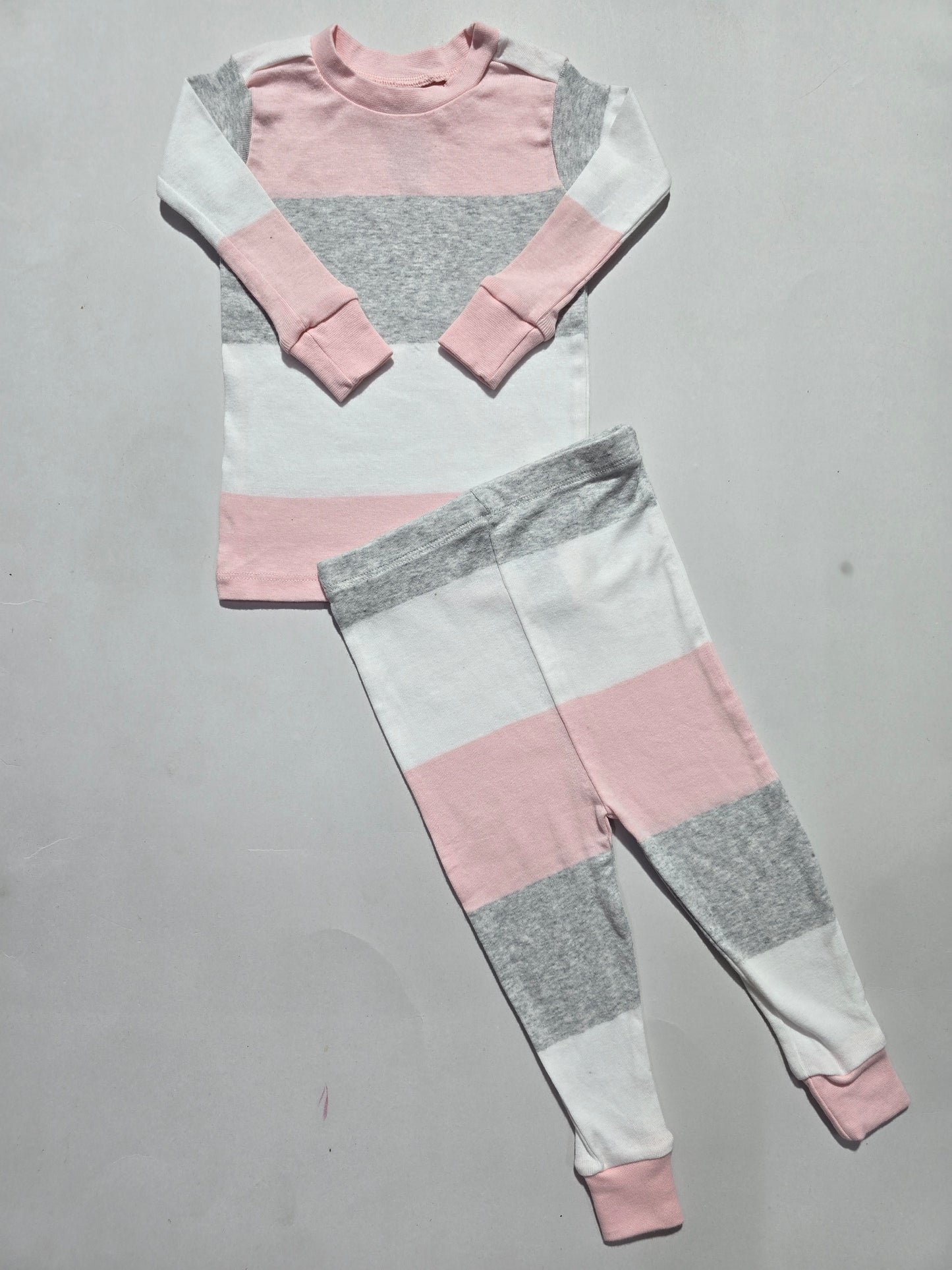 Color-blocked fabric with pink, gray, and white sections on a gray background