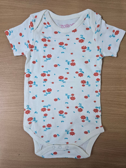 Baby's rompers - White with orange flowers