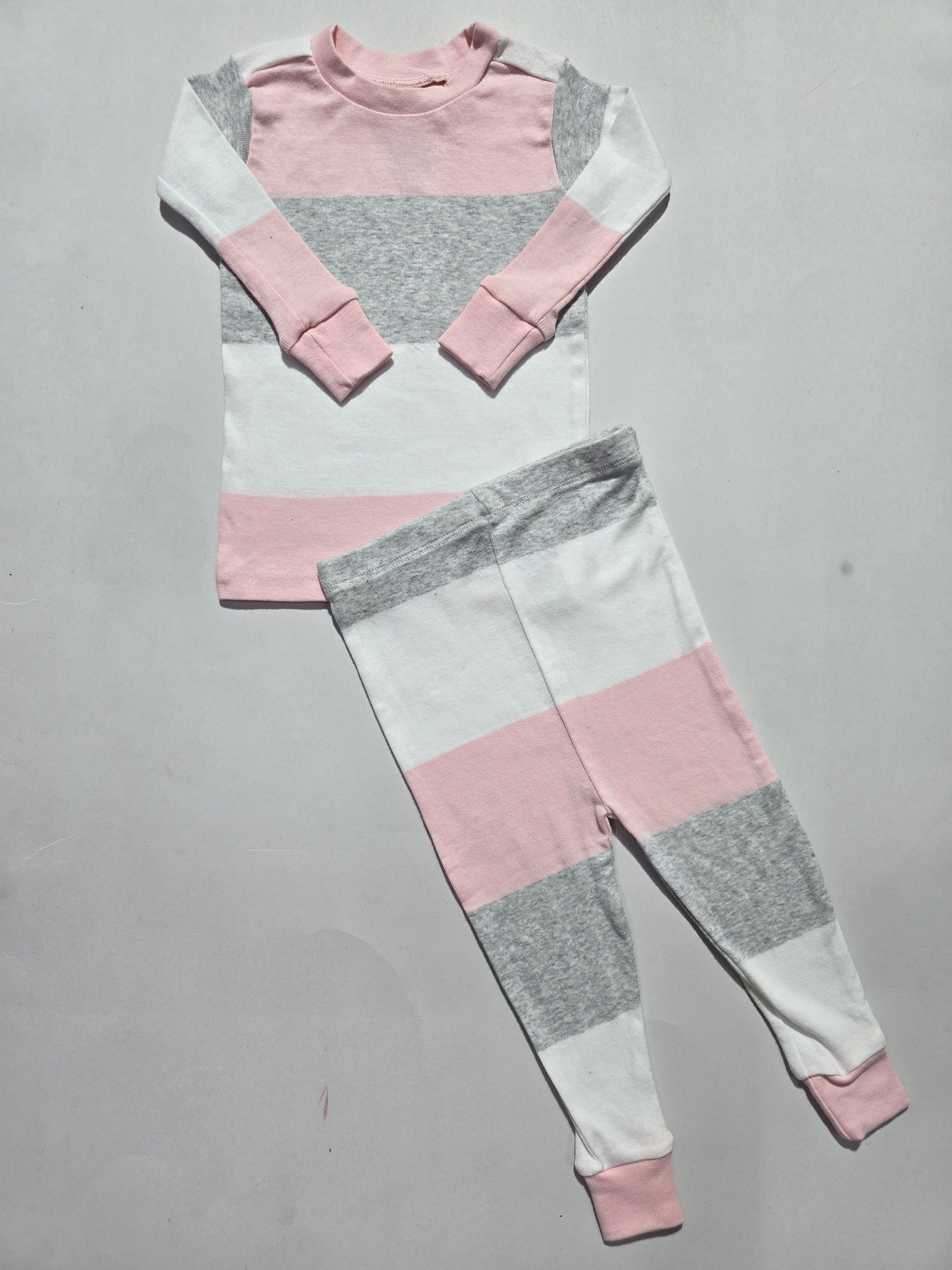 Color-blocked fabric with pink, gray, and white sections on a gray background